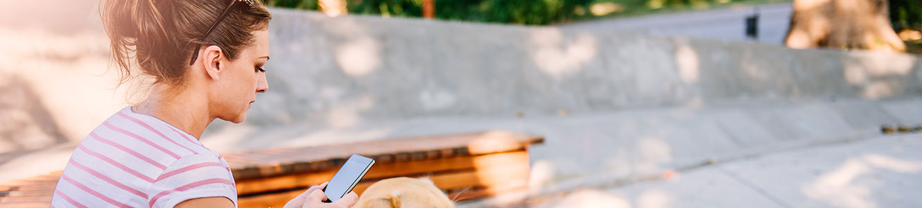 Young woman using her phone outside.