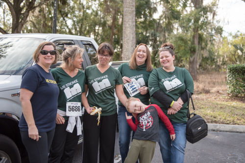 Members of Team Mainstreet cheering section laughing after the MeStrong 5K race in DeLand