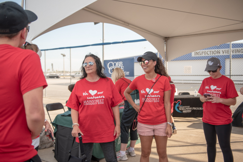 Members of Team Mainstreet chatting before the Heart Walk at Daytona International Speedway