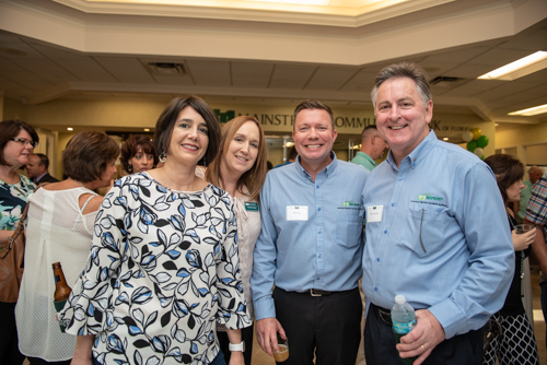 Team Mainstreet posing for a portrait with guests during Clermont's 2nd Anniversary Celebration