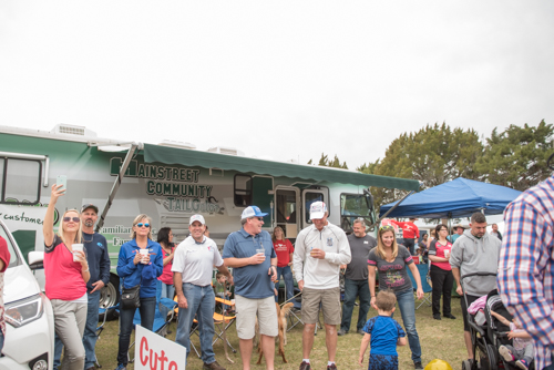 Group gathered in front of the Mainstreet Community Bank RV enjoying Pig on the Pond event