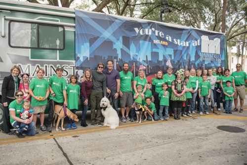 Group portrait of Team Mainstreet in front of the Mainstreet RV before the Mardi Gras on Mainstreet Parade