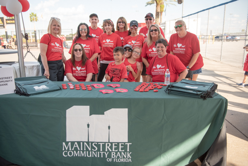 Team Mainstreet handing out bags before the Heart Walk at Daytona International Speedway