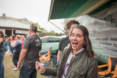 Woman smiling and dancing during Pig on the Pond event