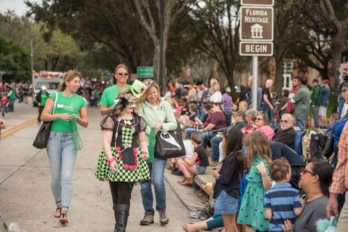 Team Mainstreet handing out candy along the parade route at the Mardi Gras dog parade in DeLand