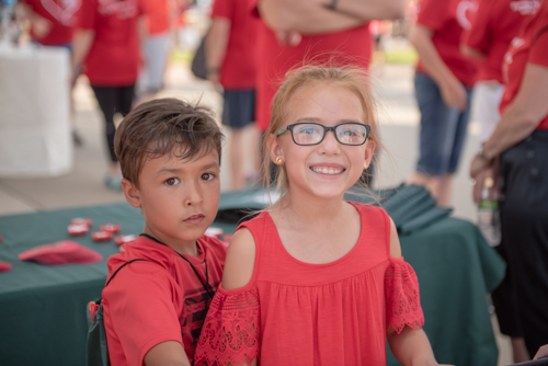 Kids of Team Mainstreet members smiling before the Heart Walk at Daytona International Speedway.