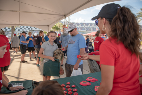 Team Mainstreet handing out bags before the Heart Walk at Daytona International Speedway