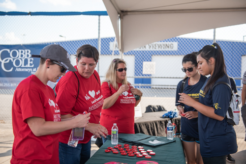 Team Mainstreet handing out bags before the Heart Walk at Daytona International Speedway