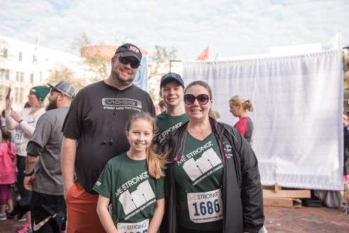 Team Mainstreet smiling for a photo after running in the MeStrong 5k race in DeLand