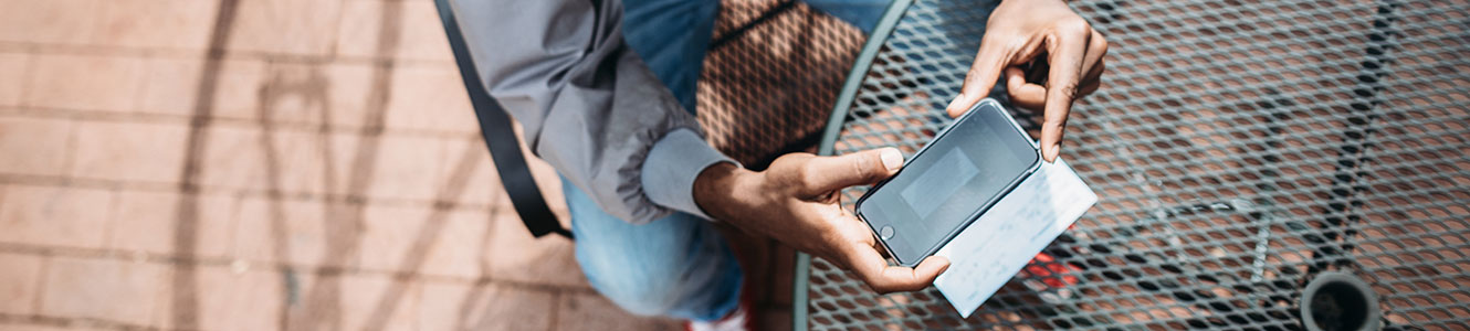 Young man depositing a check with his phone.