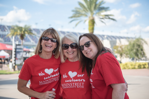 Members of Team Mainstreet smiling for a picture before the Heart Walk at Daytona International Speedway.