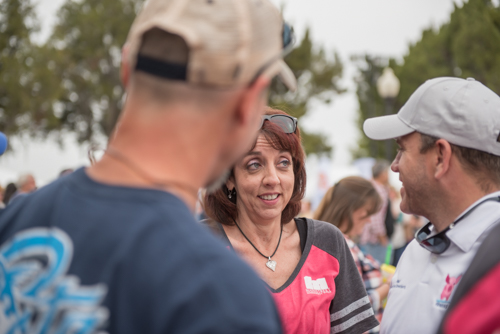 Woman looks at man during conversation at Pig on the Pond event