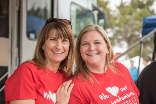 Two female Mainstreet team members smiling for a photo at Pig on the Pond in Clermont