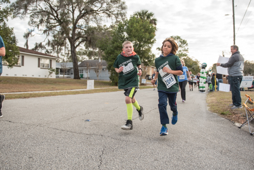 Two children of Mainstreet team members running in the MeStrong 5k race in DeLand