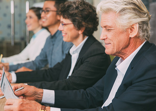 People of various ages sitting at a meeting.