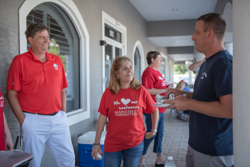 Mainstreet team members chat with a customer during Customer Appreciation in Holly Hill