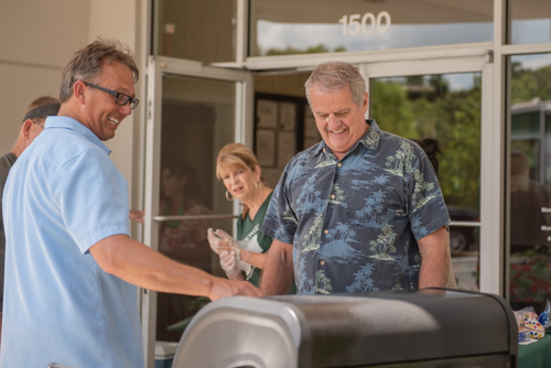 Mainstreet employees laugh as another employee looks on during Customer Appreciation Day