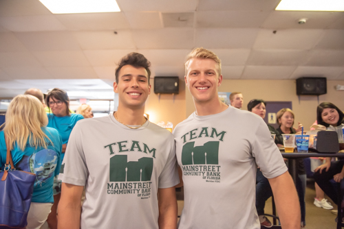 Two men smile wearing Mainstreet Community Bank tshirts