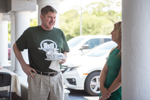 Two team members chat while eating lunch at Customer Appreciation Day in East Volusia