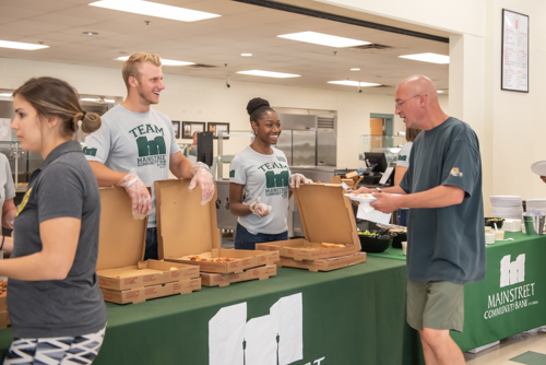 Man and woman greet teachers for lunch provided by Mainstreet Community Bank