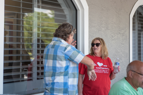 A customer and team member chat at Customer Appreciation Day at the Mainstreet Community Bank branch in East Volusia