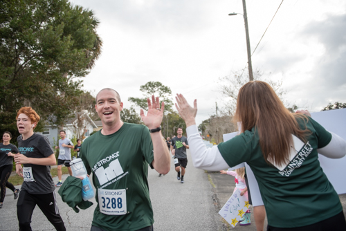 Team Mainstreet members give each other high fives during race in DeLand