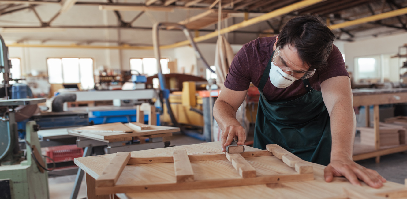 Carpenter working on project in shop.