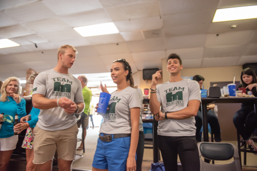 Two men and a woman talk while at bowling alley in DeLand FL