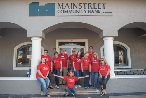 East Volusia team members pose for a picture outside of Mainstreet Community Bank