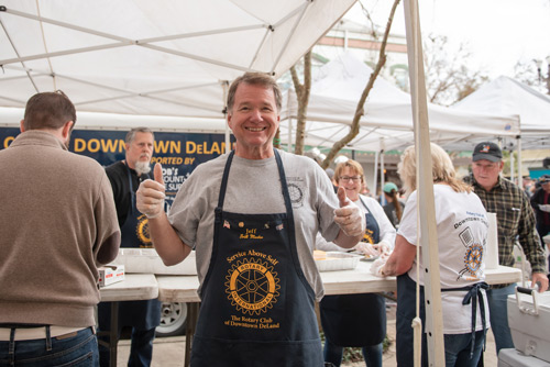 Member of Team Mainstreet gives thumbs up while volunteering at MeStrong Race