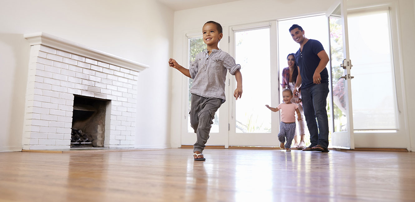 Young family entering their new house.