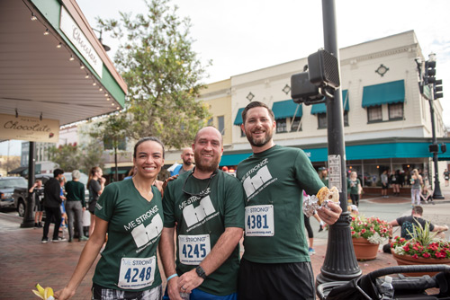 Three people smile on street after MeStrong race in DeLand