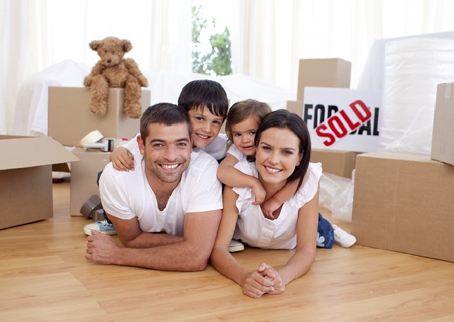 Family of four with moving boxes.
