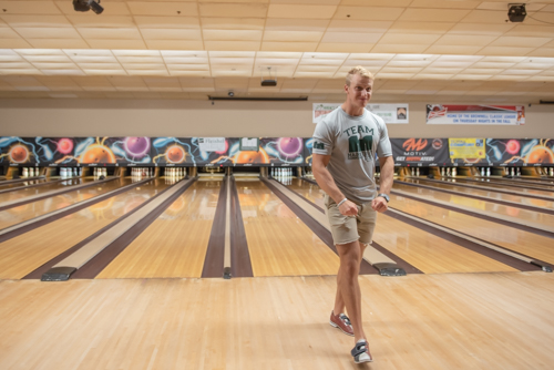 Excited man after bowling a strike at bowling alley