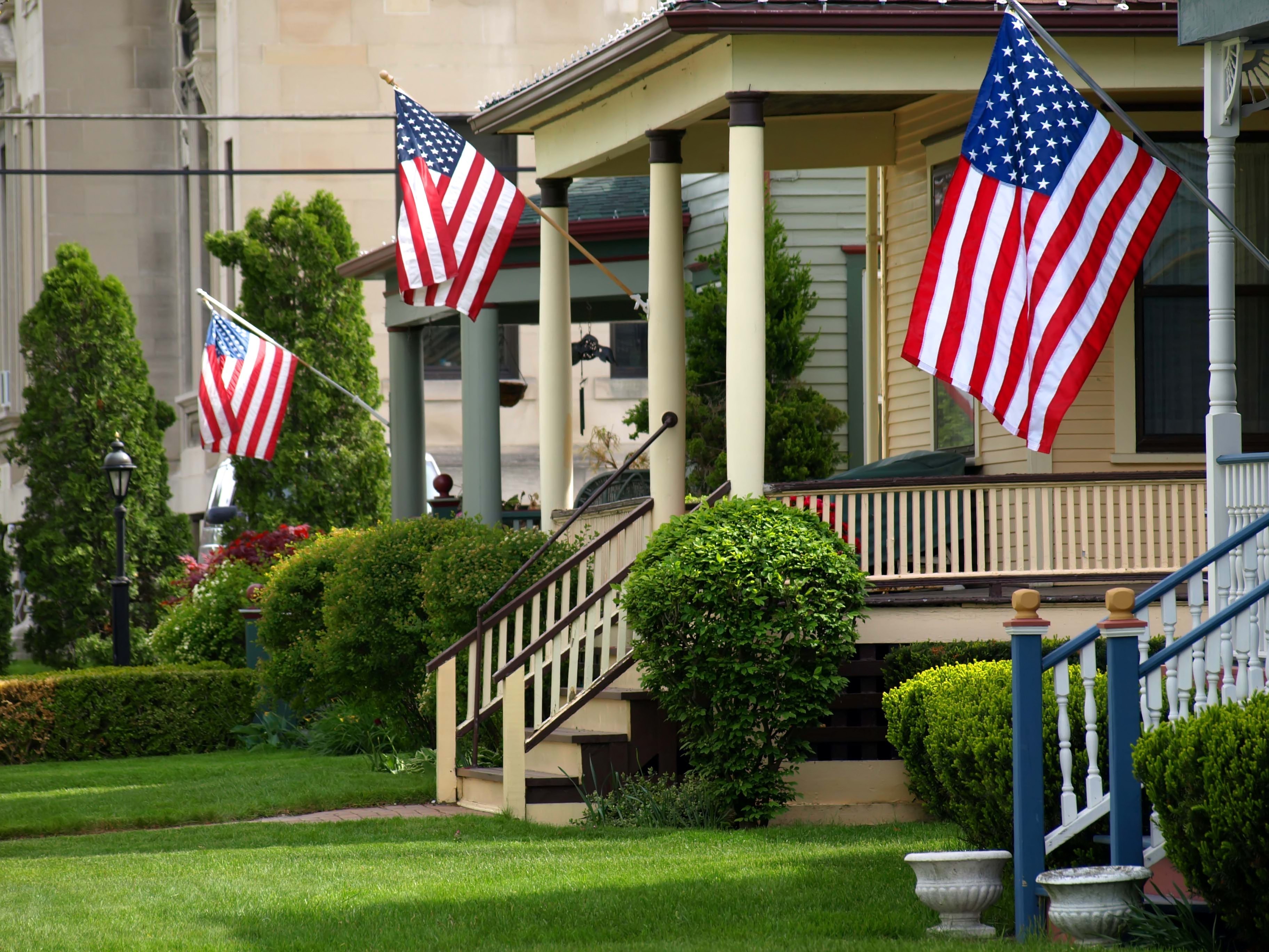 Small town front porch with American flags