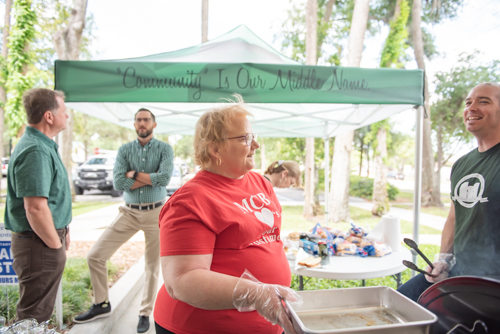 Mainstreet Community Bank employees chat while making food for Customer Appreciation Day in downtown DeLand
