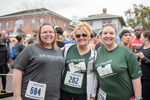 Three ladies smile before MeStrong race