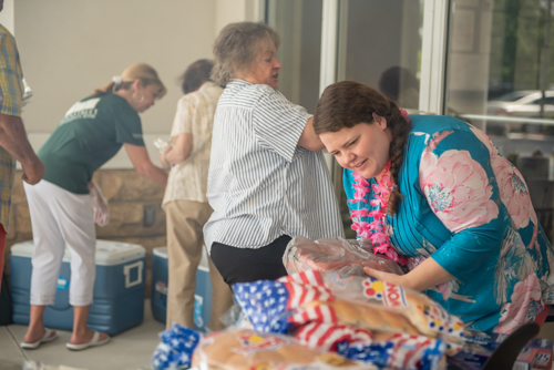 A Mainstreet Community Bank employee helps prepare food for Customer Appreciation Day