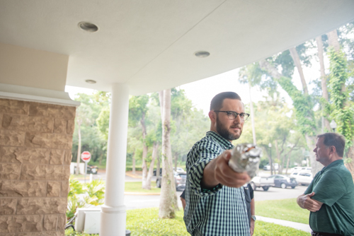 An employee points a hot dog during Customer Appreciation Day at Mainstreet Community Bank