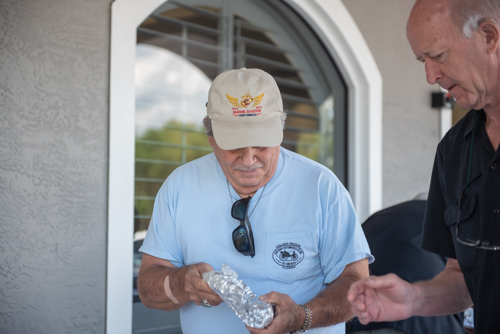 Two men unwrap their hot dogs during Mainstreet Community Bank's Customer Appreciation Day.