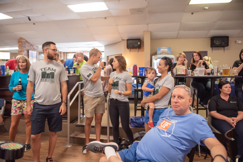 A group of people from Mainstreet Community Bank chat before Bowling for Literacy event begins in DeLand