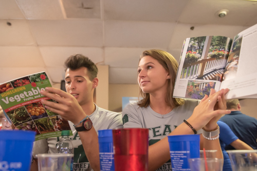 A man and a woman look through gardening books that were received in auction fundraiser during Bowling for Literacy in DeLand FL