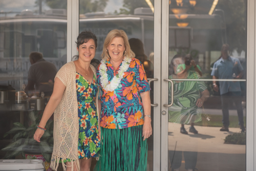 Two Mainstreet Employees smile in front of the North Spring Garden Branch during Customer Appreciation Day