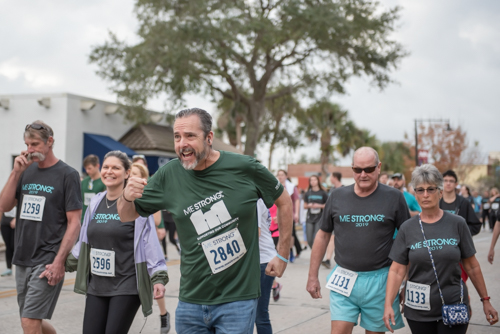 Member of team Mainstreet pretends to run hard during MeStrong race