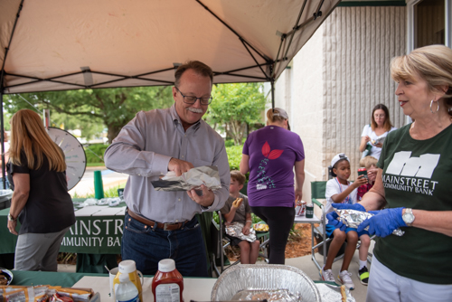 A customer prepares his lunch during Mainstreet Community Bank Customer Appreciation Day in Orange City
