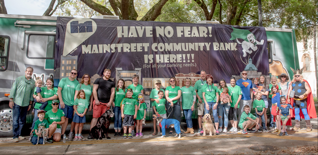 Group photo of Team Mainstreet before Mardi Gras Dog Parade in DeLand