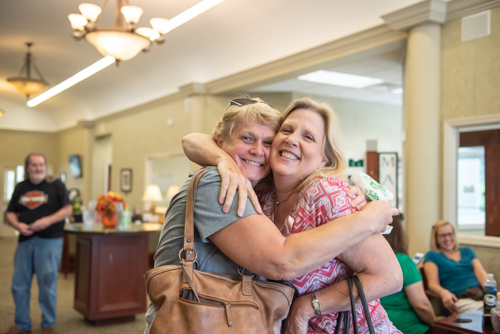 Mainstreet Team member hugs a friend during customer appreciation day