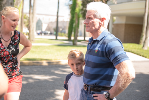 A man and child chat outside Mainstreet Community Bank in DeLand