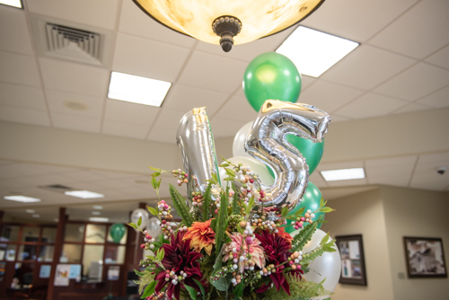 Balloons in the shape of a 1 and a 5 displayed during customer appreciation day in Orange City