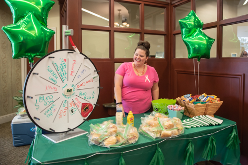 Team member smiles while giveaway wheel spins at Customer Appreciation Day